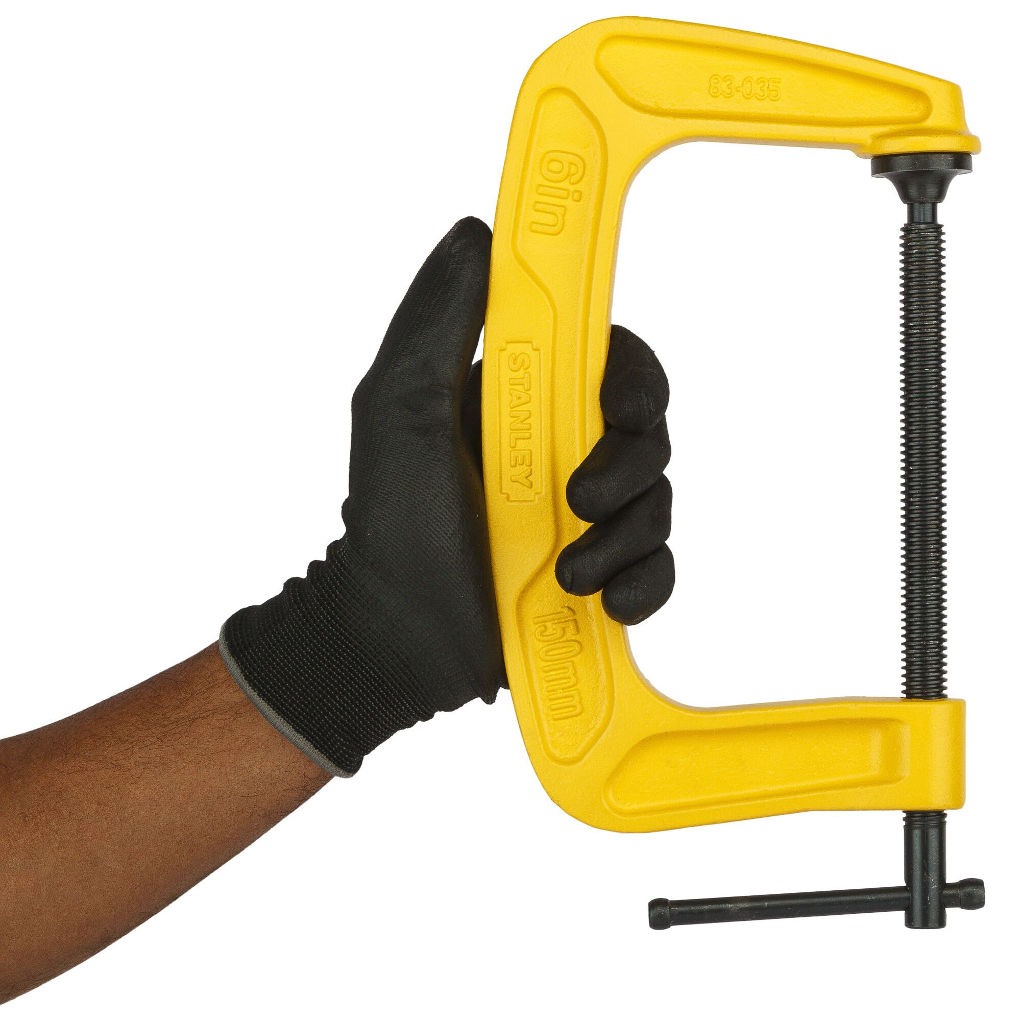 Photo of STANLEY 0-83-035 C-clamp, yellow, held in hand with black glove, front angle.