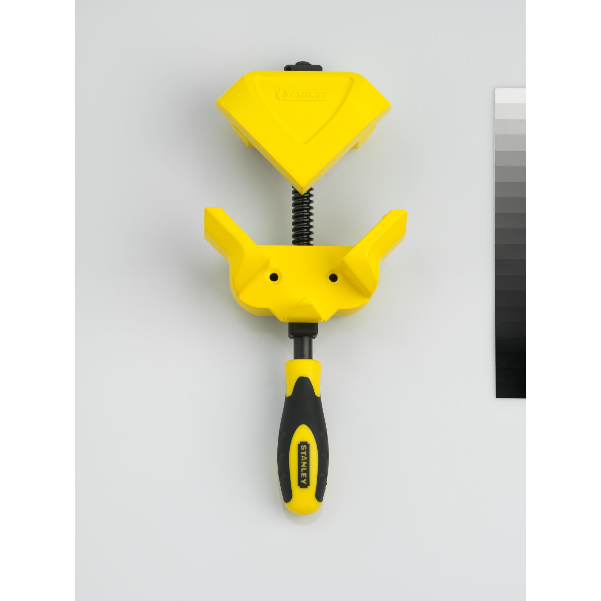 STANLEY 0-83-122 corner clamp tool, yellow and black, flat lay angle.