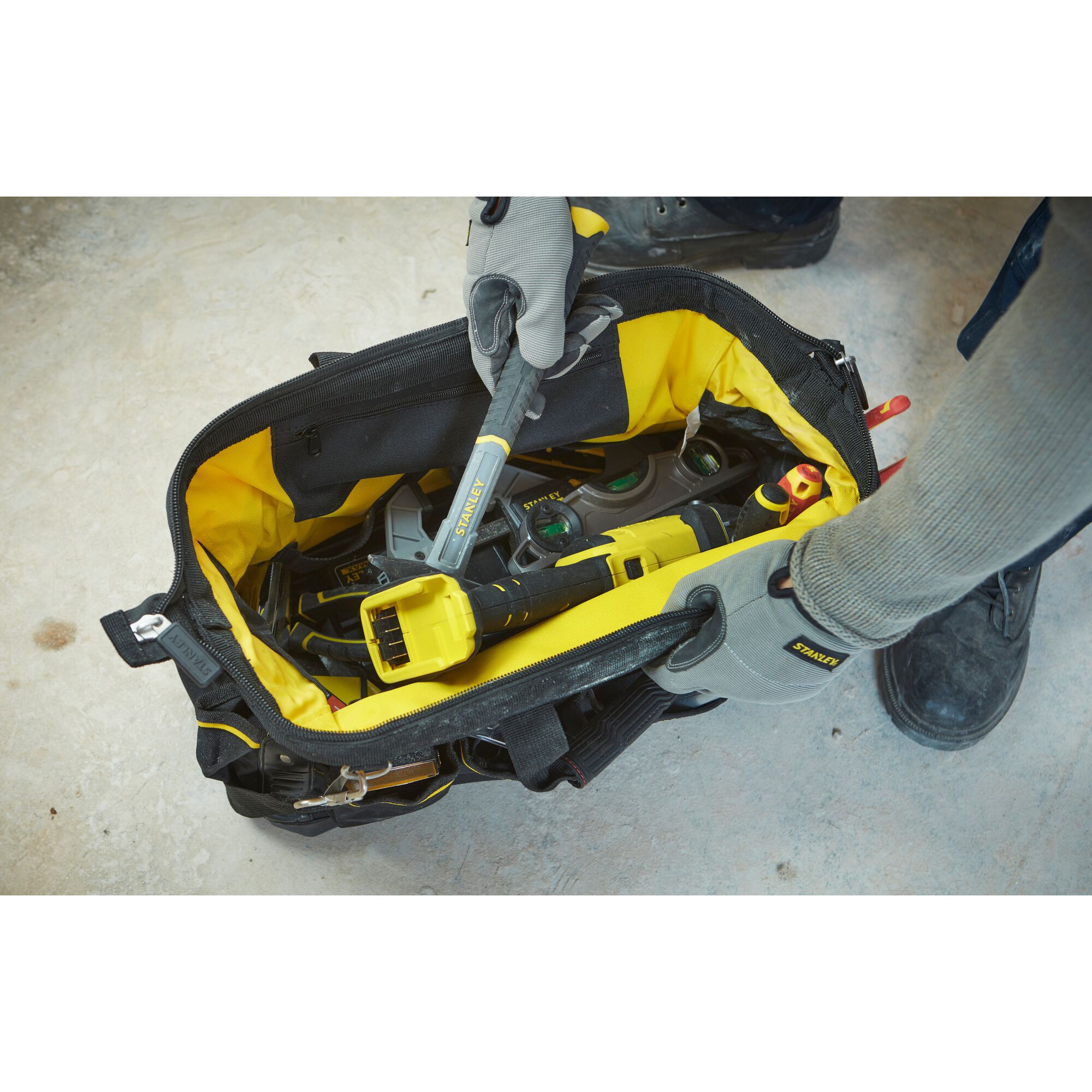 Photo of STANLEY 1-93-950 tool bag open, filled with assorted hand tools, viewed from above.