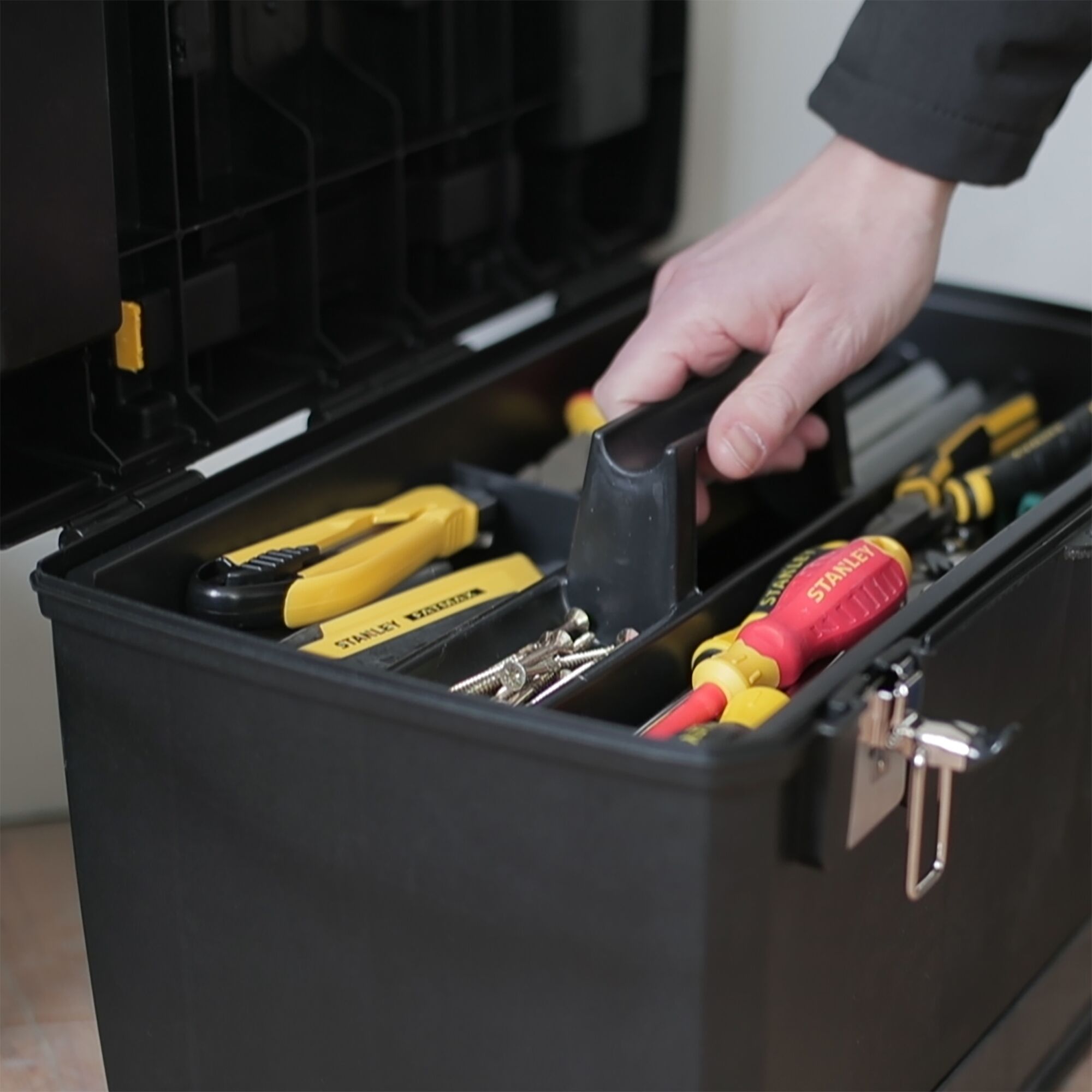 STANLEY 1-93-968 toolbox photography showing organized tools and screws with a hand lifting the tray.