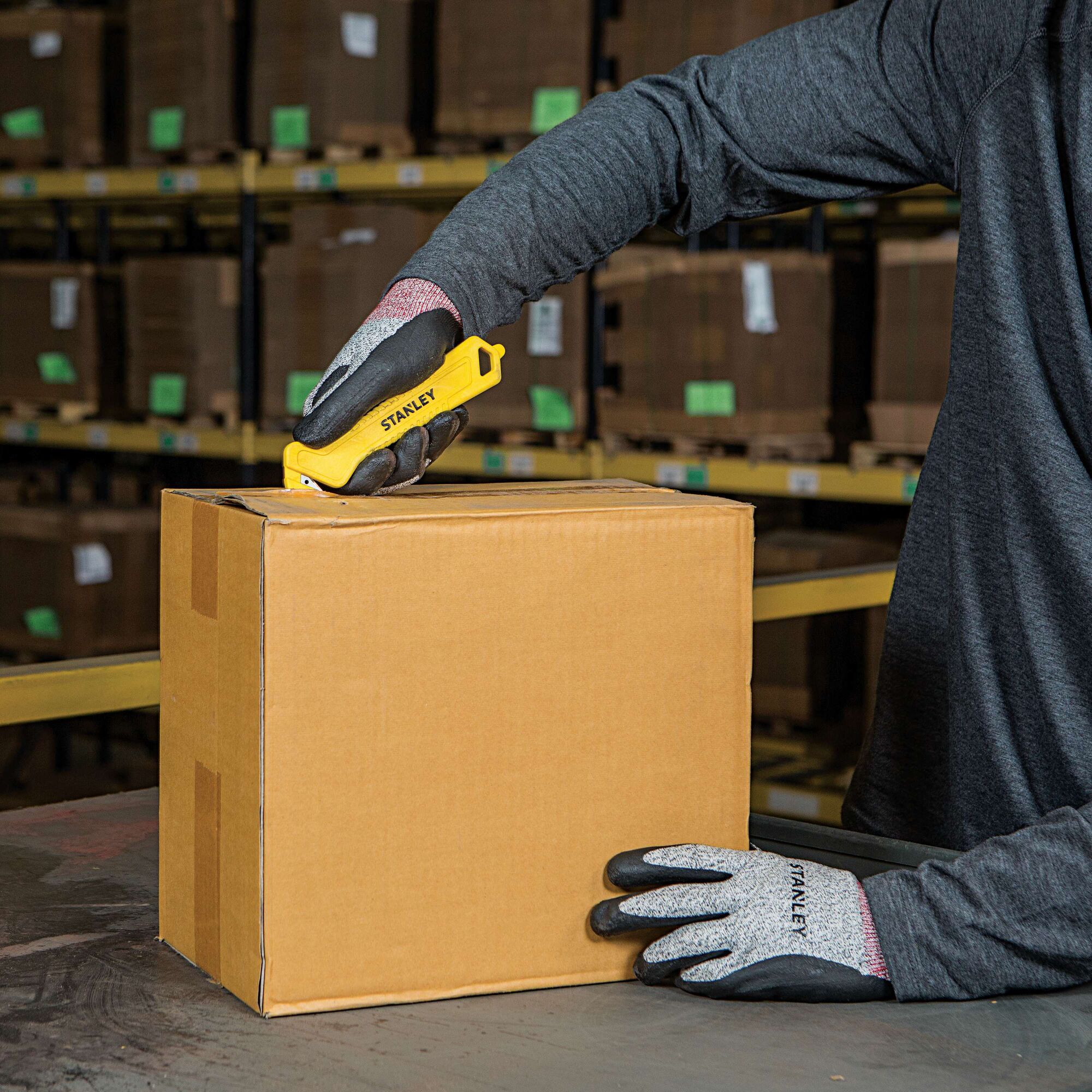Single Sided Pull Cutter being used for opening box.