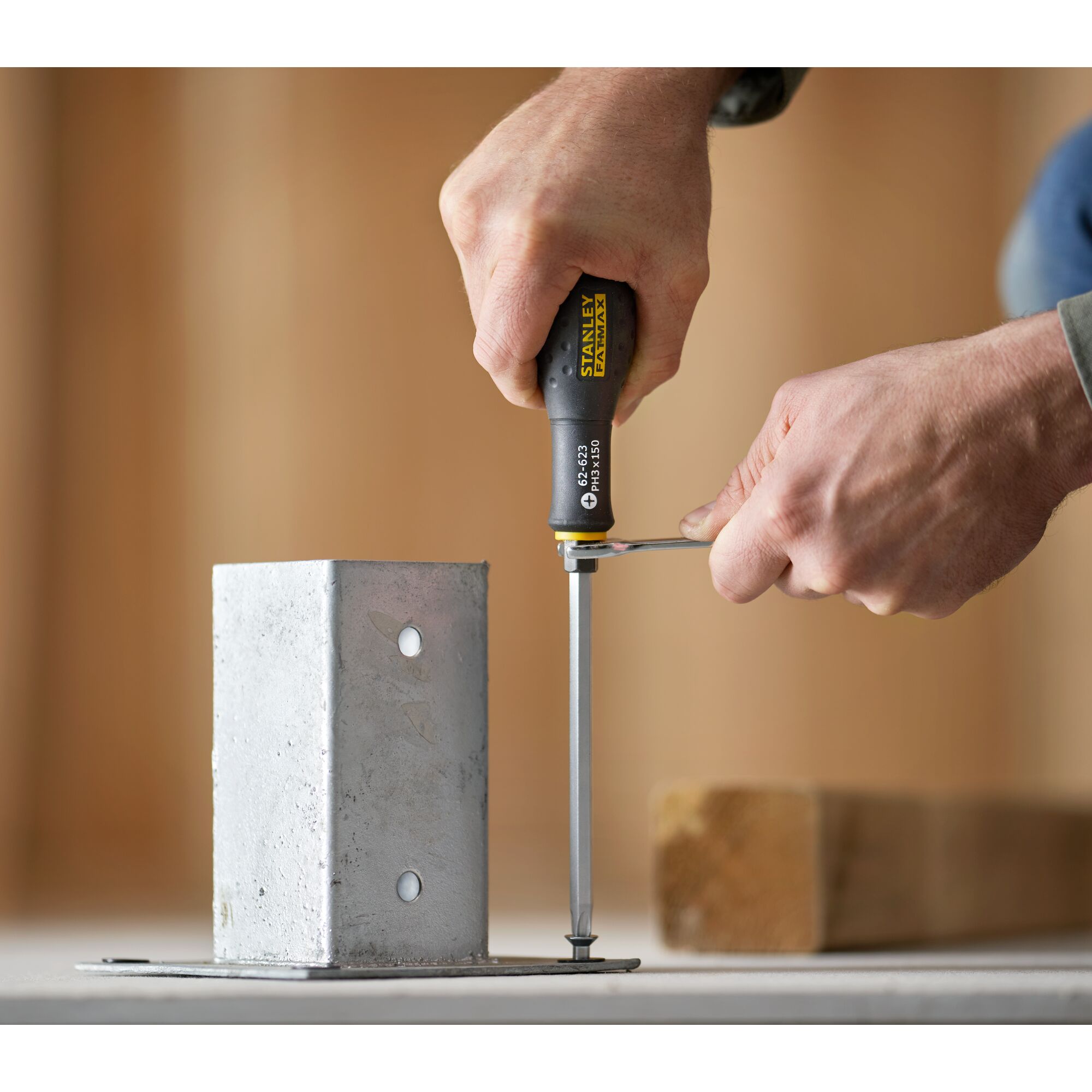 Photo of STANLEY FMHT0-62623 screwdriver being used to tighten a screw in a metal bracket.