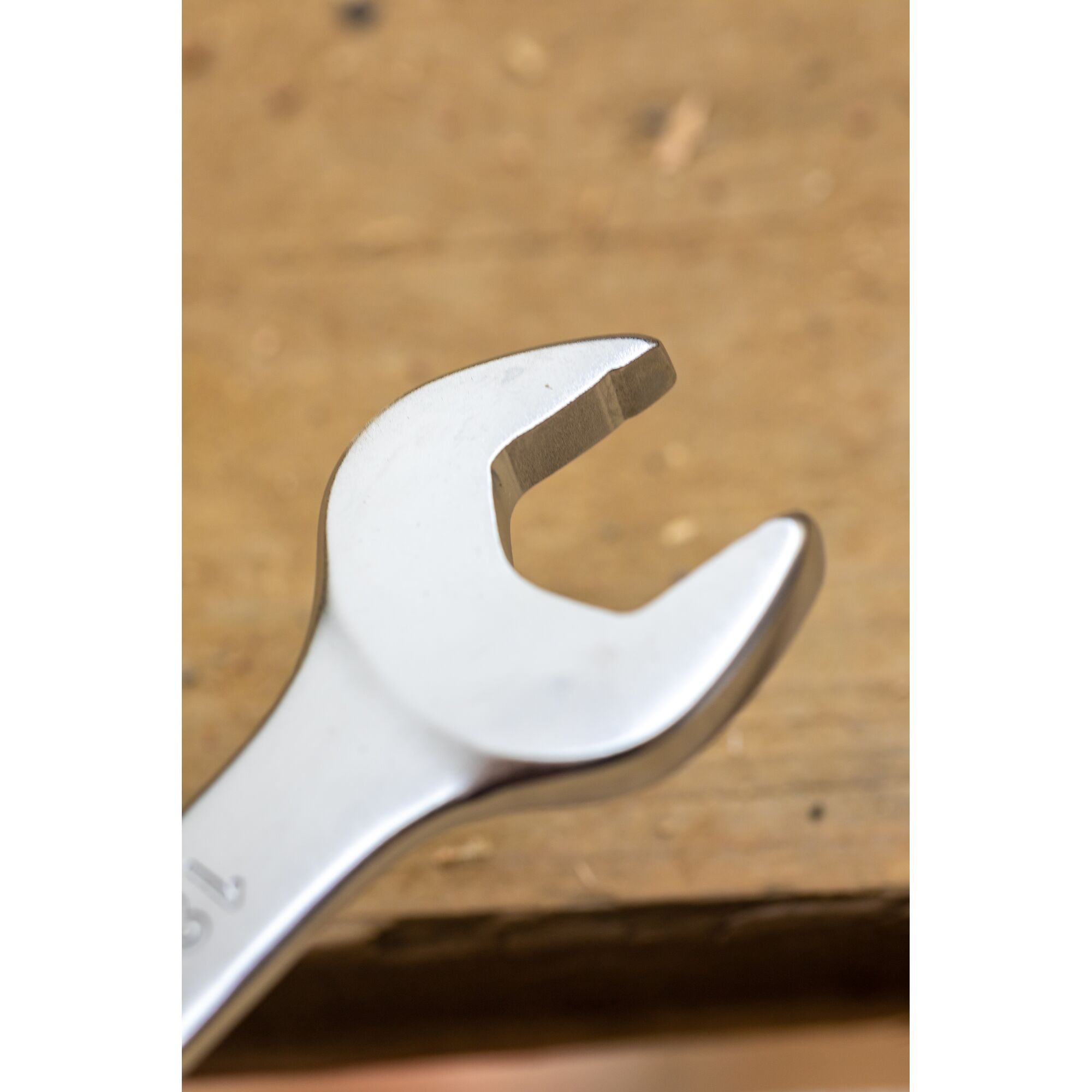 STANLEY FMMT13086-0 open-end wrench, close-up on metallic tool over wood surface, photography category