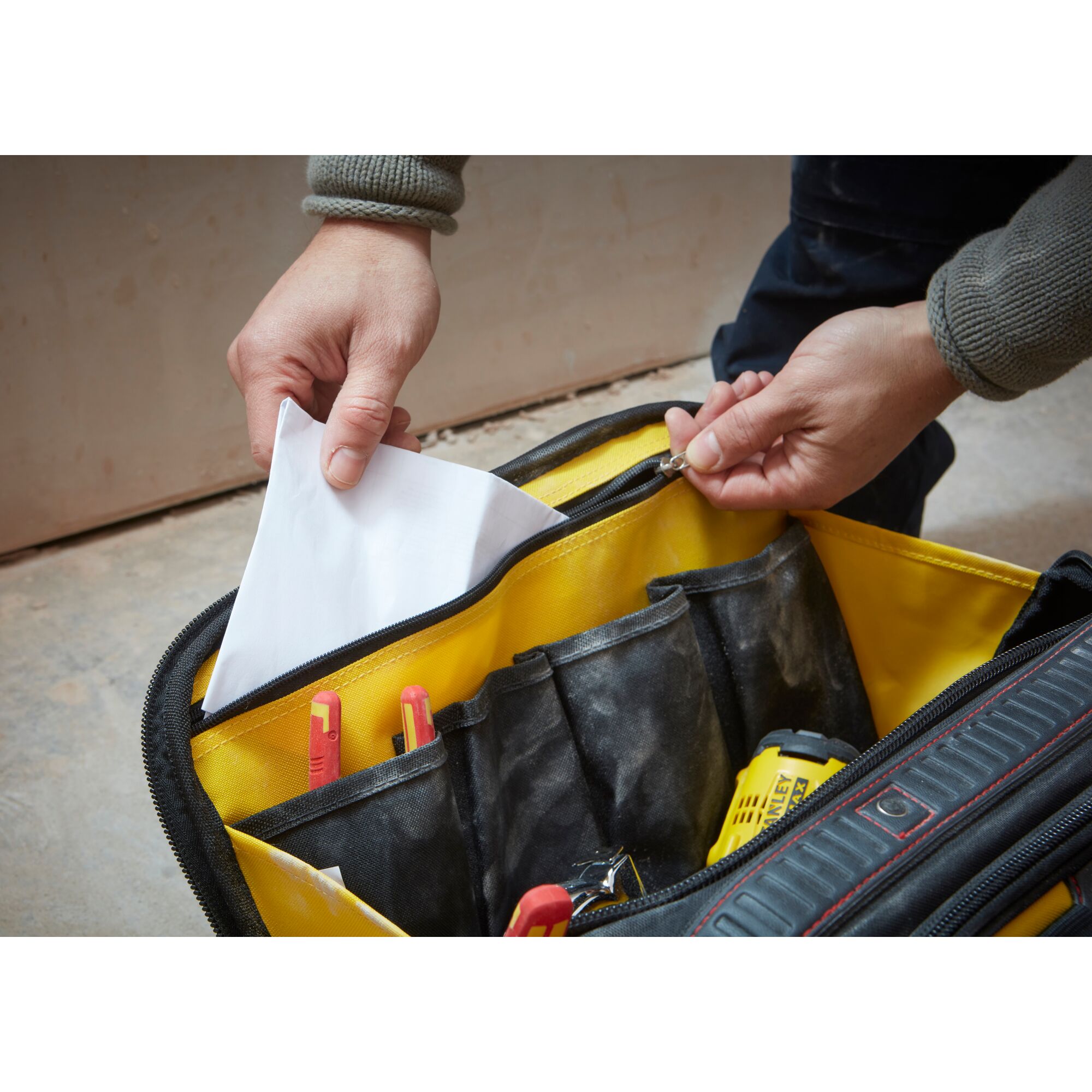 Photo of STANLEY FMST1-73607 tool bag with yellow interior, showing pockets and storing tools and documents.
