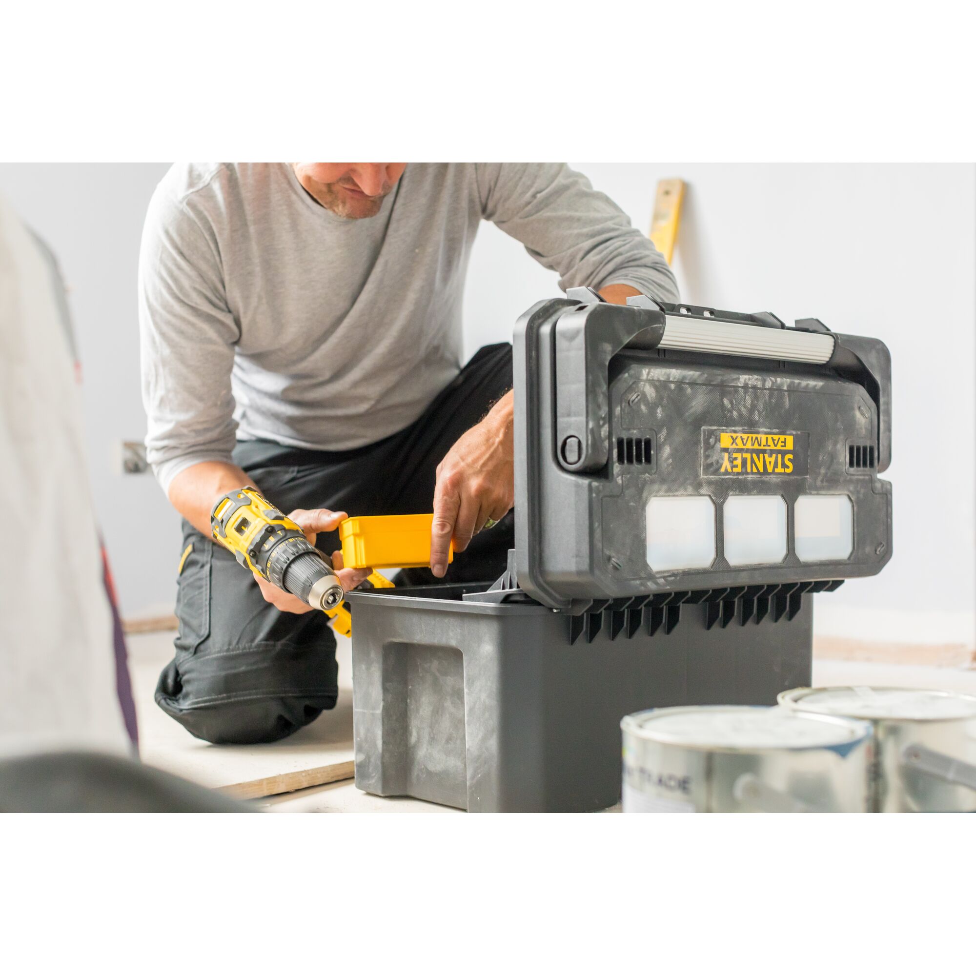 Photo of STANLEY FATMAX FMST1-75792 toolbox in use, open on the floor with tools inside.