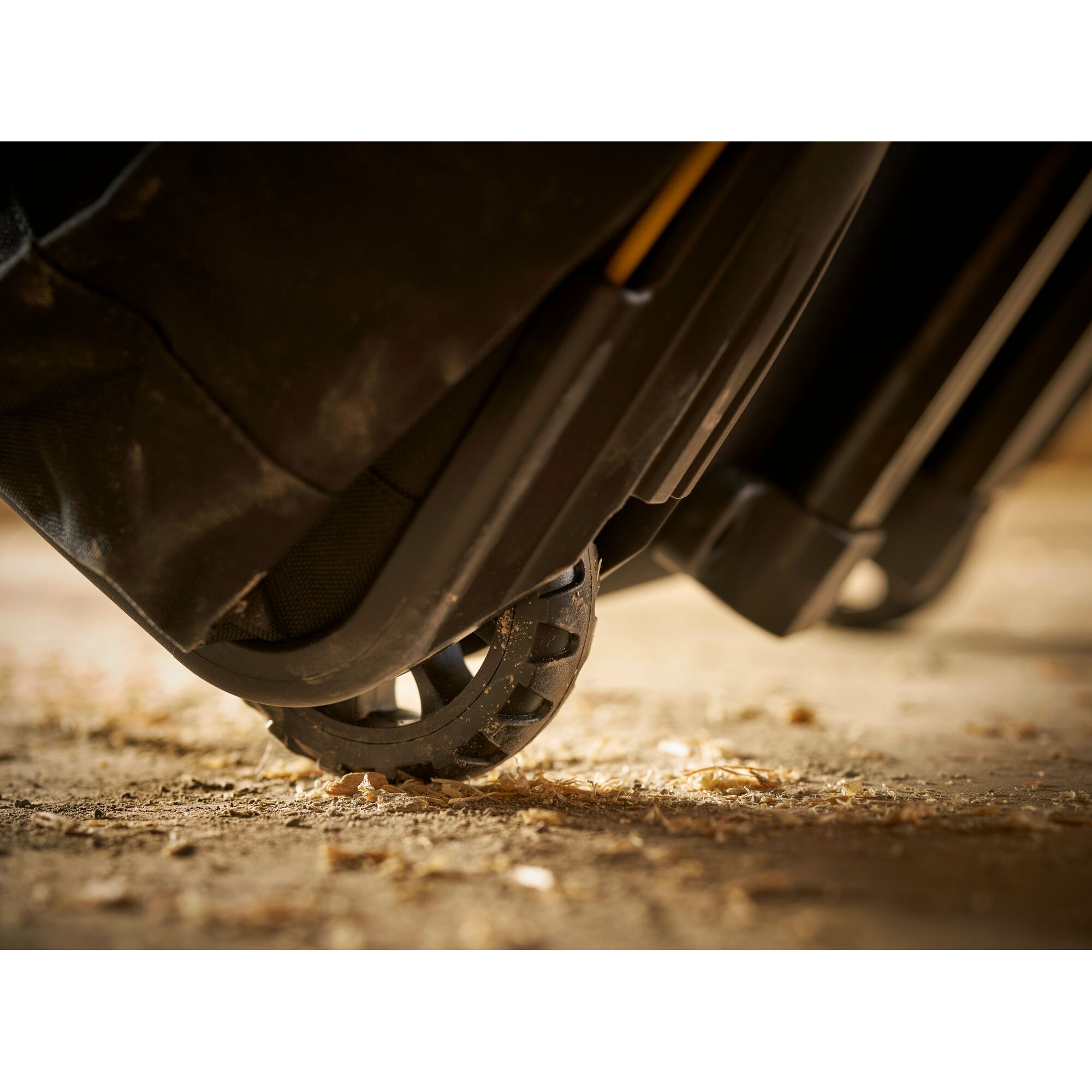STANLEY FMST1-80148 tool bag wheel close-up on rough ground, photography showing durable construction.