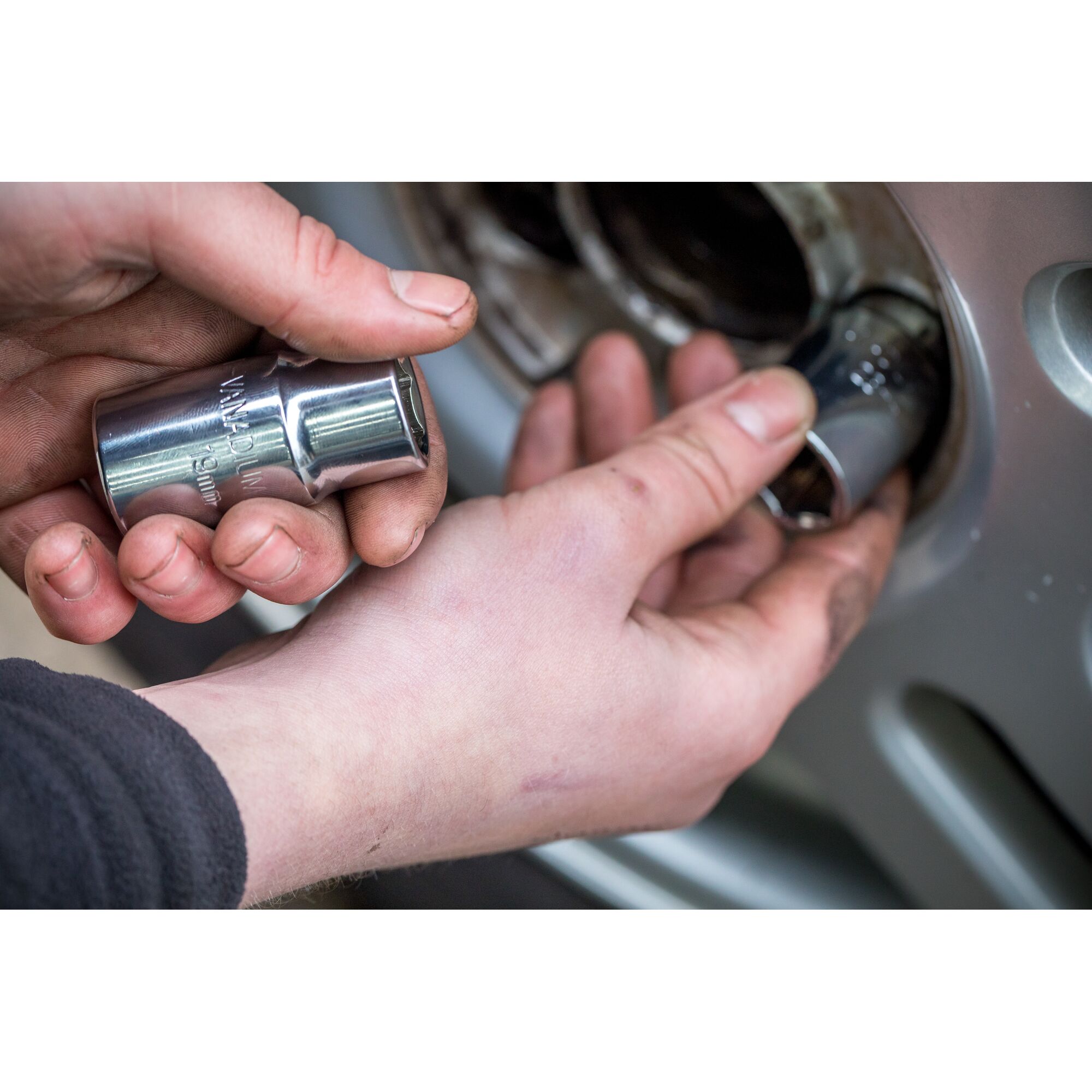 Photo of STANLEY STHT80890-0 socket being used to remove a lug nut from a vehicle wheel.