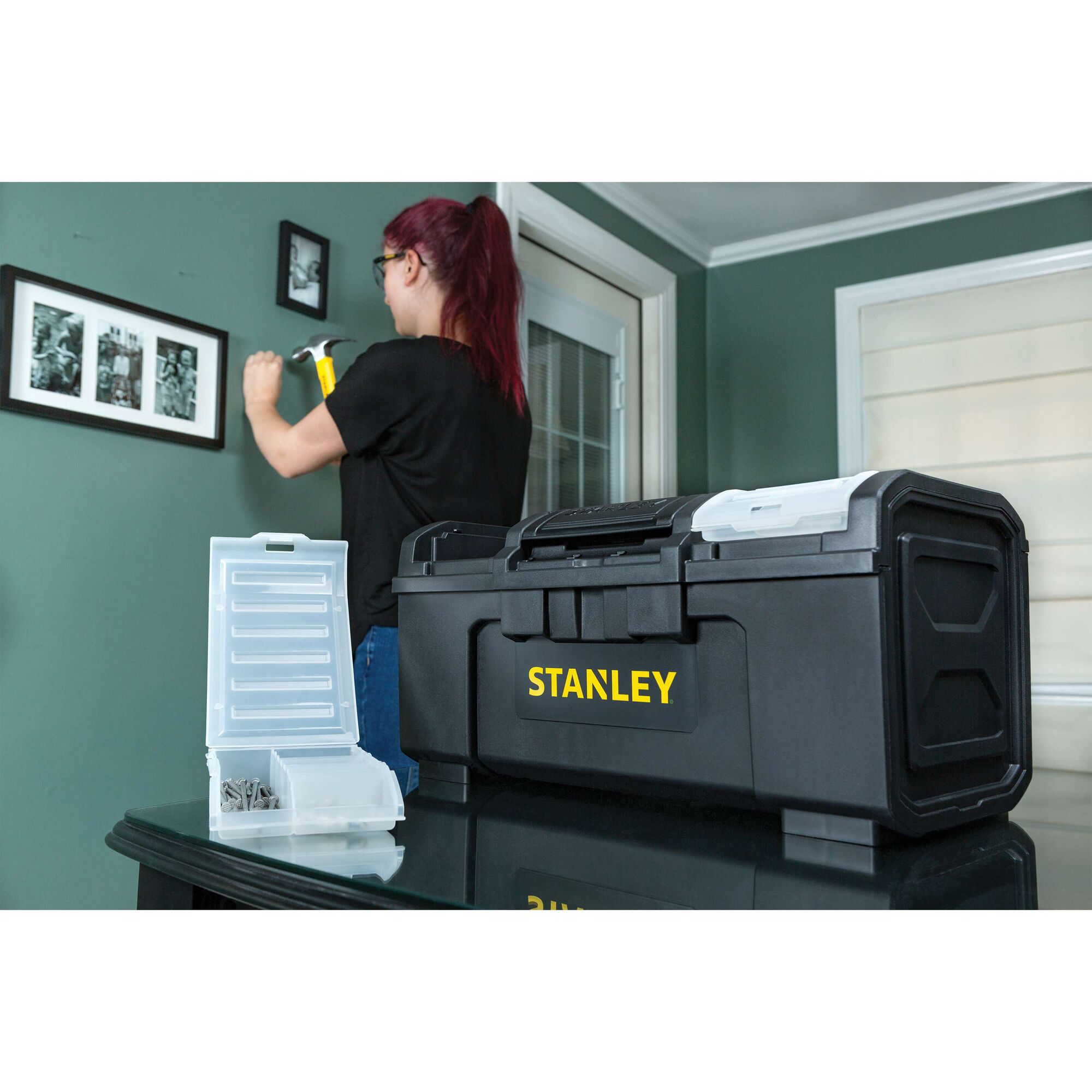 STANLEY STST19420 black toolbox with yellow logo on table, open organizer box with hardware beside it, indoor room background.